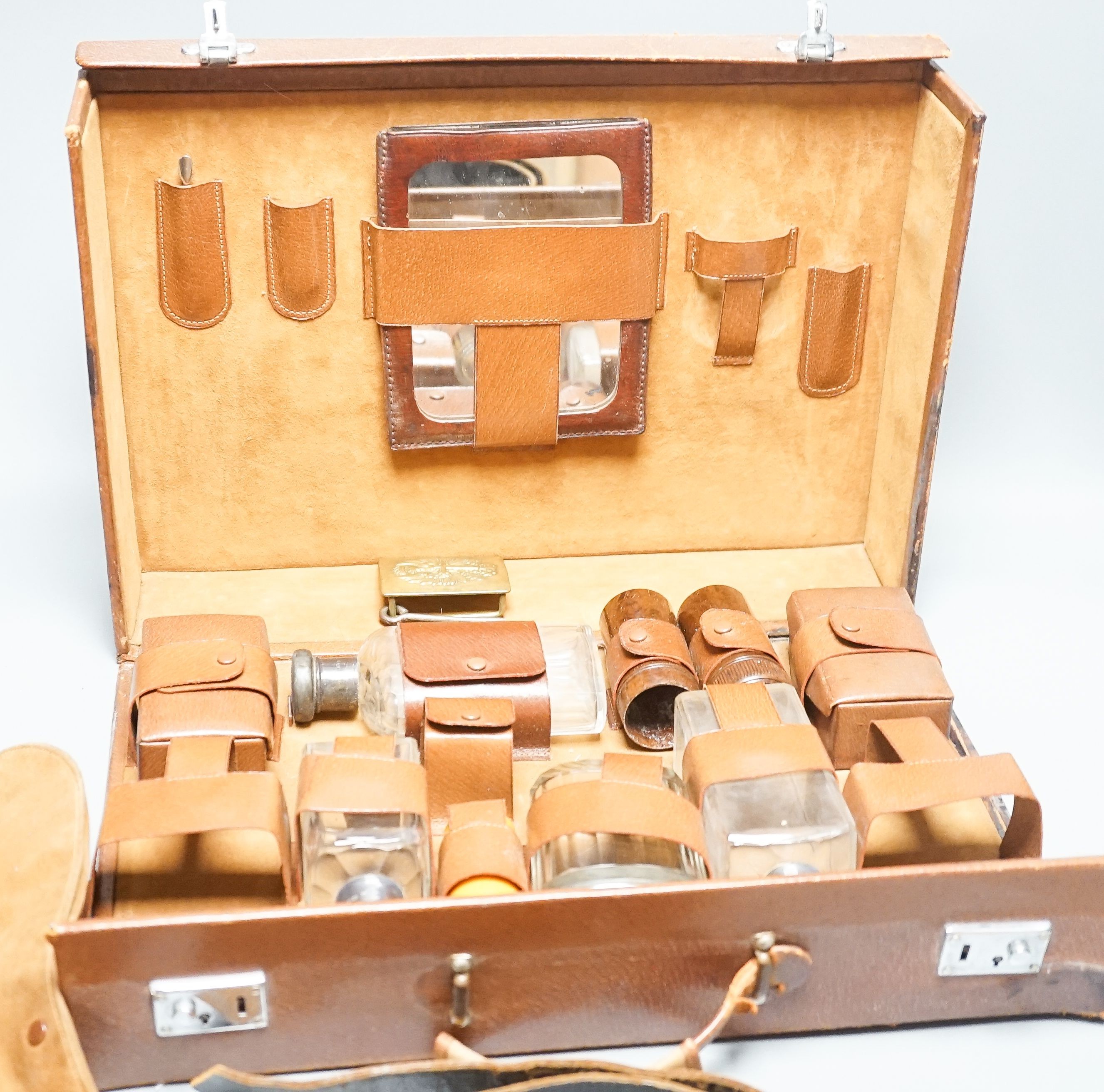 Leather travelling toilet set, some silver lids, and belt.